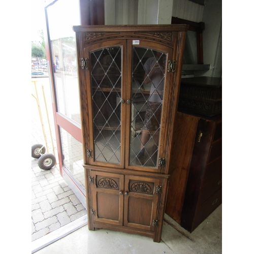 2063 - An oak and lead glazed corner cupboard