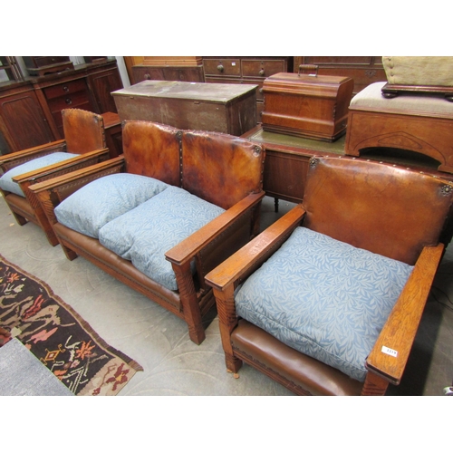 2219 - A 1930's oak framed sofa and two arm chairs with brown studded leather