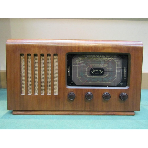 7034 - A Hollybush table top valve radio in veneered wooden case with sloping front. C.1947