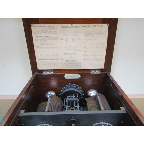 7046 - A W.G. Pye model 720 two valve radio, housed in walnut cabinet  with paper instructions attached to ... 