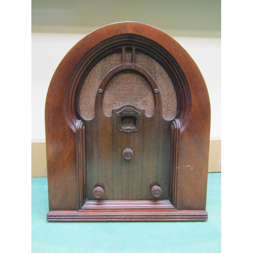 7063 - A Philco model 56 valve radio in domed walnut veneered cathedral cabinet designed by Clyde Shuler. C... 