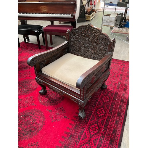 1019 - An early 20th Century Chinese rosewood lounge suite consisting of four heavily carved armchairs toge... 