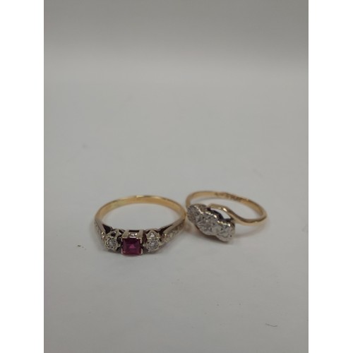 1294 - A 9ct gold and platinum crossover ring set with central diamond chip and a gold, ruby and diamond ri... 