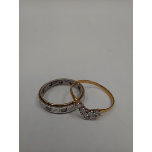 1295 - A 9ct gold ring set with white gemstones in V formation and a white gold and silver eternity ring (2... 