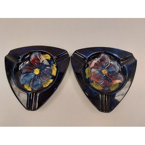 1298 - Two Moorcroft ashtrays decorated with a central flower