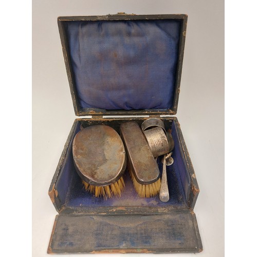 1357 - A box containing silver and sterling items; brushes, napkin rings, spoons, etc