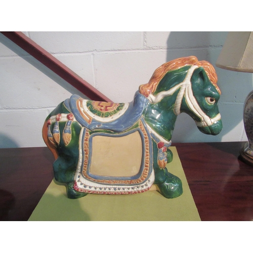 1005 - An ornamental ceramic horse. 47cm length