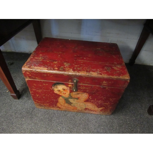 1017 - A red painted wooden box, decorated with a small child and  a rodent.  46 x 32 x 31cm
