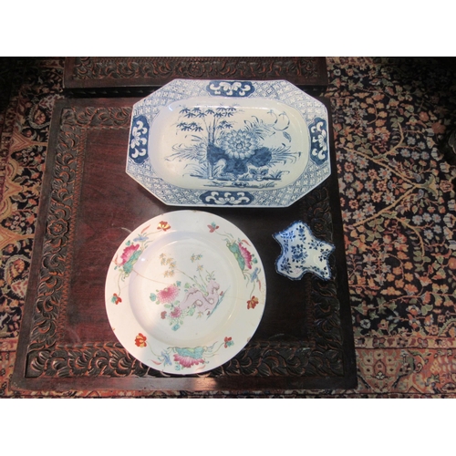 1021 - A blue and white serving dish and a polychrome plate (repaired), both bearing paper labels reputedly... 