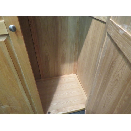 1057 - A natural oak two door wardrobe, 200cm high x 118cm wide x 64cm deep