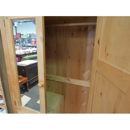 1059 - A natural pine compactum wardrobe with mirrored door over three drawers and full height door, 190cm ... 