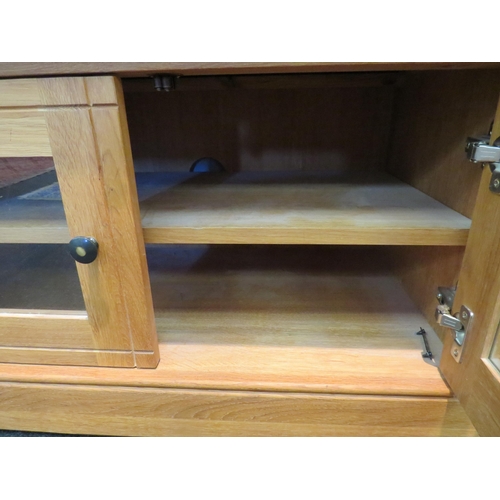 1068 - An oak cabinet, single drawer over cupboard doors revealing shelved interior. 57cm high x 88cm wide ... 