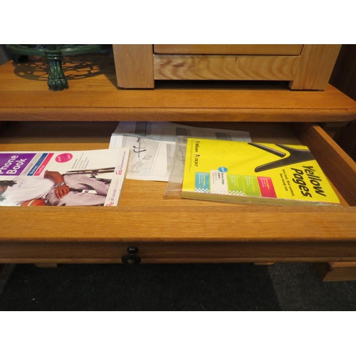 1068 - An oak cabinet, single drawer over cupboard doors revealing shelved interior. 57cm high x 88cm wide ... 