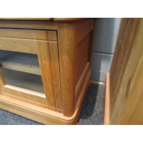 1068 - An oak cabinet, single drawer over cupboard doors revealing shelved interior. 57cm high x 88cm wide ... 