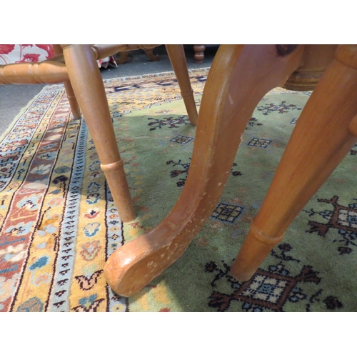 1074 - A modern pine circular kitchen table with a set of three lathe back beech chairs