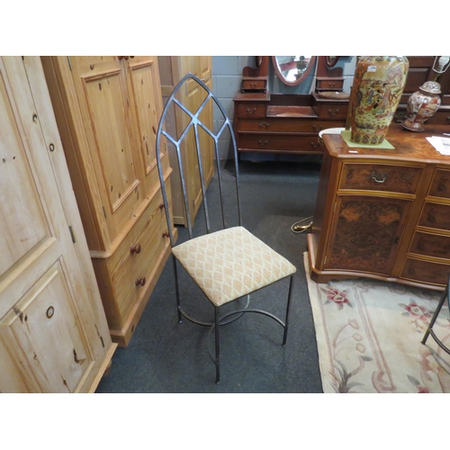 1085 - A circular glass table on iron base with a set of six iron frame arch chairs