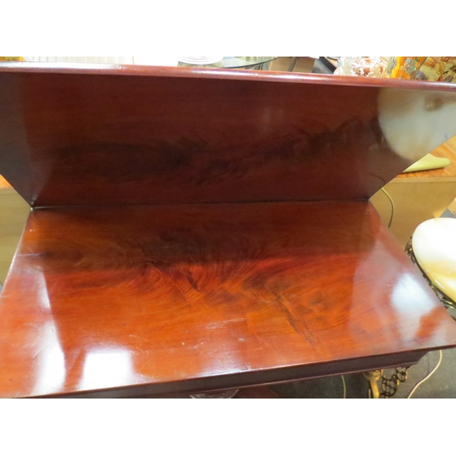 1091 - An early 19th Century mahogany folding tea table on a panelled column and concave rectangular platea... 