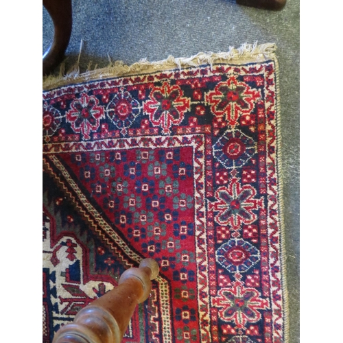 1128 - An eastern wool rug with red ground central lozenge and multiple borders a/f 163cm x 120cm