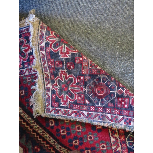 1128 - An eastern wool rug with red ground central lozenge and multiple borders a/f 163cm x 120cm