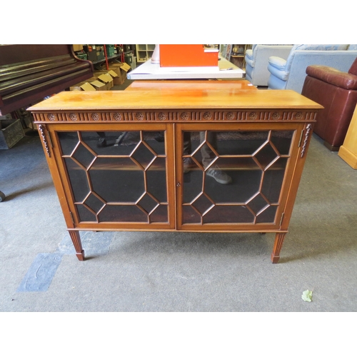 1198 - An early 20th Century walnut low bookcase, astragal glazed doors, on spade legs, 76cm high x 101cm w... 