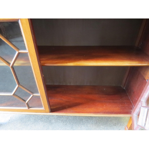 1198 - An early 20th Century walnut low bookcase, astragal glazed doors, on spade legs, 76cm high x 101cm w... 