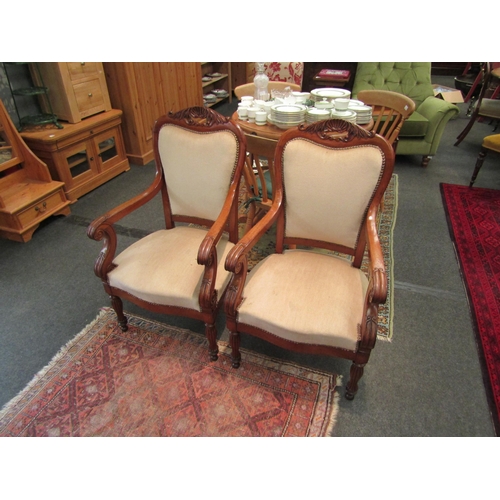 1547 - A pair of Irish mahogany chairs with shell detail, scroll arms and reeded legs   (R) £450