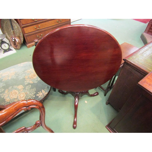 4109 - A George III revival mahogany revolving circular tilt top wine table on a bird cage action turned an... 