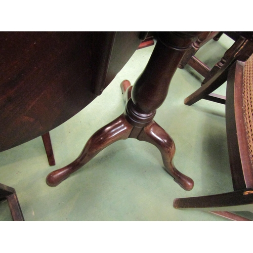 4159 - Circa 1780 a mahogany circular tilt top wine table on baluster turned column on pad foot tripod base... 