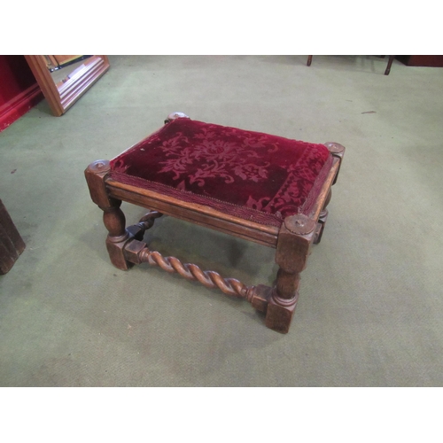 4009 - An oak footstool with barleytwist stretchers, velveteen fabric upholstery