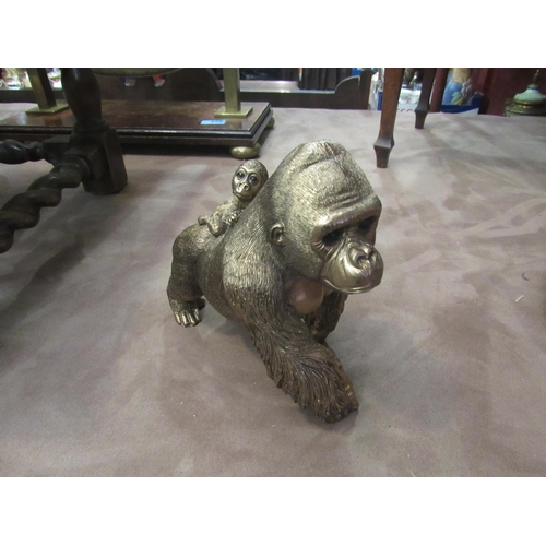 4011 - A bronzed effect gorilla with baby on back, 16cm high