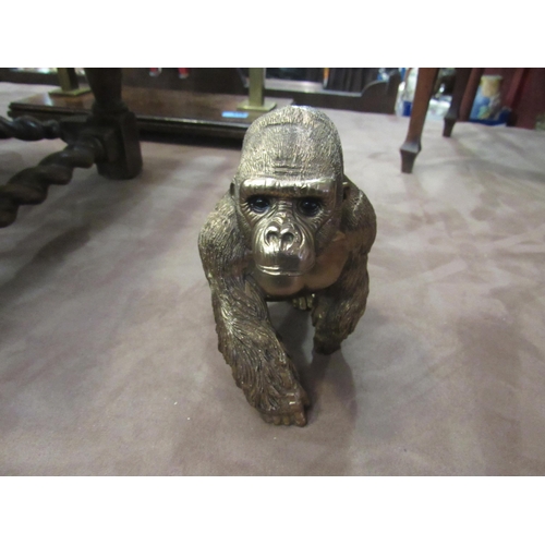 4011 - A bronzed effect gorilla with baby on back, 16cm high