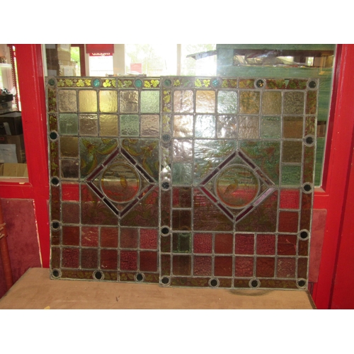 4015 - A pair of leaded/stained glass windows each 64cm x 46cm with avian/foliate decoration, a/f