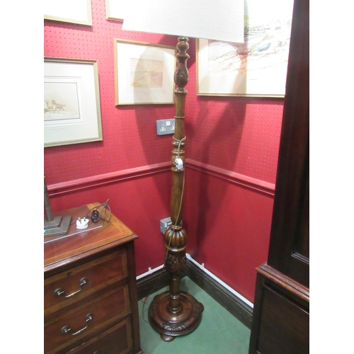 4039 - An oak standard lamp with shade the turned column with fluted and carved Tudor Rose decoration on a ... 