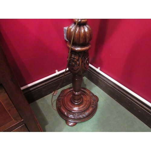 4039 - An oak standard lamp with shade the turned column with fluted and carved Tudor Rose decoration on a ... 