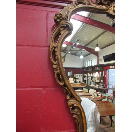 4112 - An ornate gilt frame wall mirror, 115cm high x 82cm wide total     (R) £60