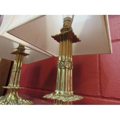 4125 - A pair of brass table lamp bases with cherubic relief