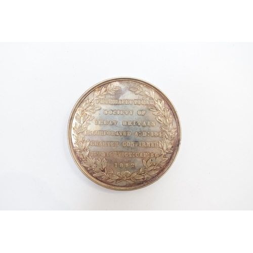 9114 - A cased Pharmaceutical Society of Great Britain silver medal designed by L.C Wyon and awarded to Aub... 