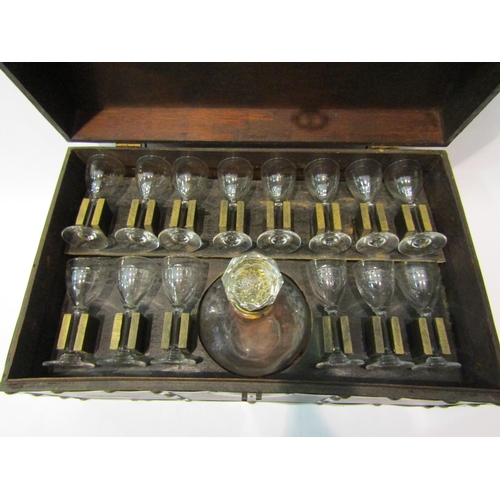 4375 - A vintage liquer set including 14 glasses and decanter all house in a fitted brass bound chest