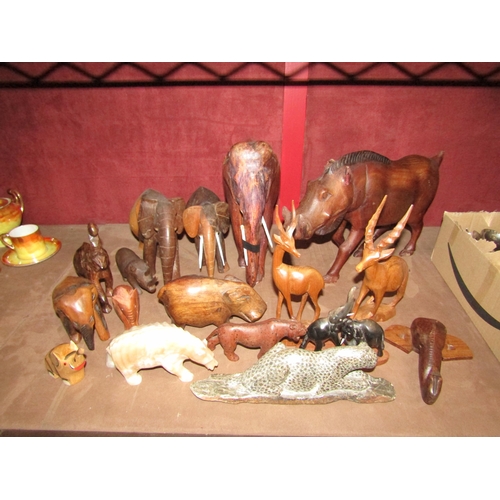 4391 - A collection of treen and carved animal figures including stone examples, elephants, hyenna, etc