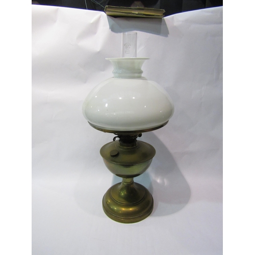 4397 - A British Made early to mid 20th Century brass oil lamp with white opaque shade