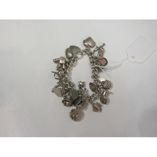 4348 - A silver curb link charm bracelet     (R) £30