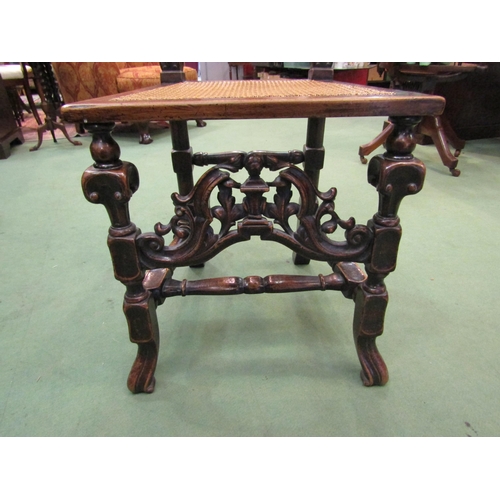 4061 - A walnut hall chair carved in Carolean style pierced with fretwork panel to front, cane work seat pa... 