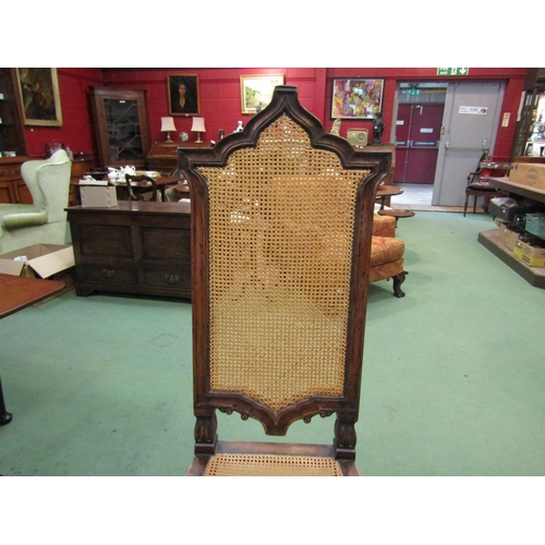 4061 - A walnut hall chair carved in Carolean style pierced with fretwork panel to front, cane work seat pa... 