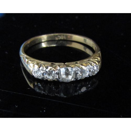 6019 - A gold ring set with five graduated diamonds, stamped 18ct, centre stone 0.20ct approx. Size Q/R, 3.... 