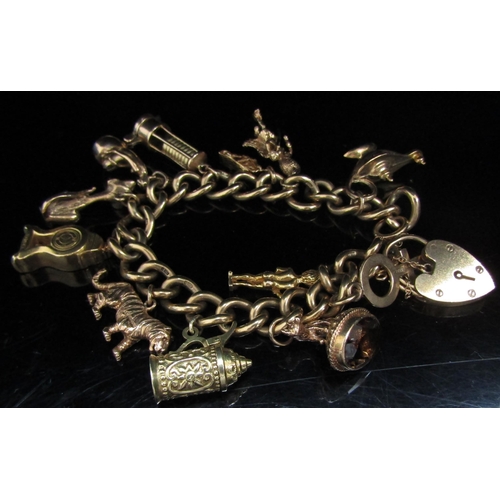 6068 - A 9ct gold charm bracelet hung with various 9ct and 15ct gold charms including, Mermaid, clock, mine... 