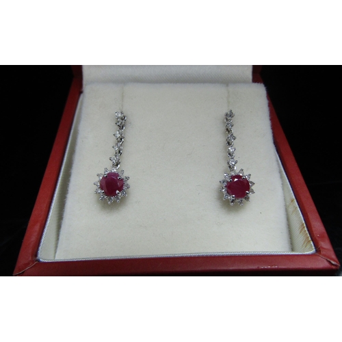 6070 - A pair of white gold ruby and diamond chip drop earrings, stamped 375, 17mm drop, 1.2g