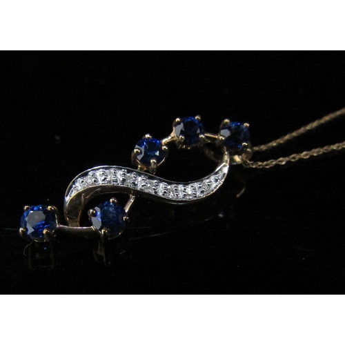 6071 - A yellow and white gold diamond chip and sapphire pendant hung on a fine chain stamped 9k, 46cm long... 