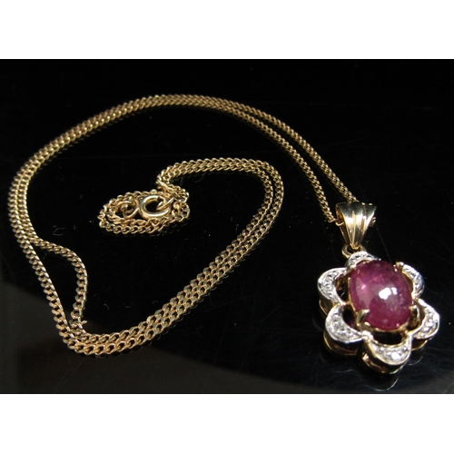 6072 - A 9ct gold ruby cabochon and diamond chip pendant hung on a fine gold chain, 46cm long, 4.7g