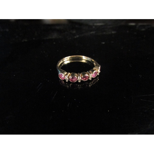 6182 - A 9ct gold ruby and diamond half hoop ring. Size L, 1.4g