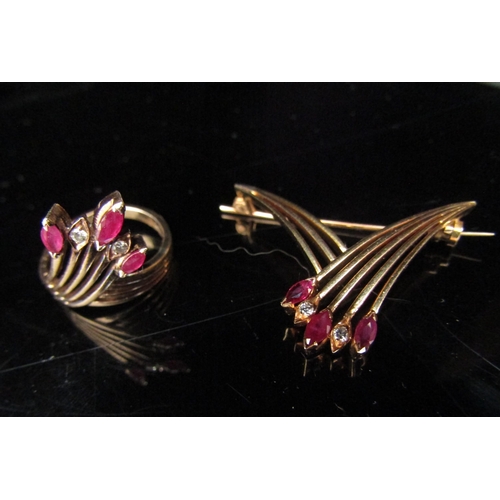 6193 - A ruby and diamond ring in a crossover spray setting, stamped 14k. Size L/M with a matching brooch, ... 